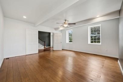 8113 Highway 22, Unit 1 New Alexandria, PA 15670 - Photo 13 of 37 an empty room with wooden floor and windows