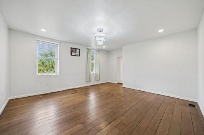8113 Highway 22, Unit 1 New Alexandria, PA 15670 - Photo 14 of 37 an empty room with wooden floor and windows