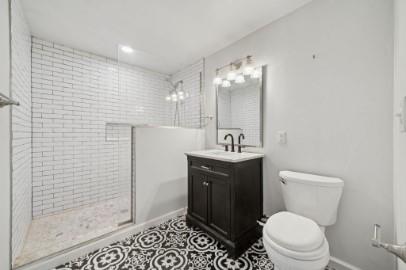 8113 Highway 22, Unit 1 New Alexandria, PA 15670 - Photo 21 of 37 a bathroom with a toilet a sink and shower