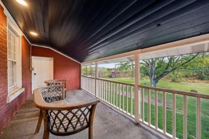 8113 Highway 22, Unit 1 New Alexandria, PA 15670 - Photo 27 of 37 a view of a porch with furniture and wooden floor