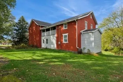 a front view of house with yard and green space