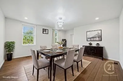 a view of a dining room with furniture and wooden floor