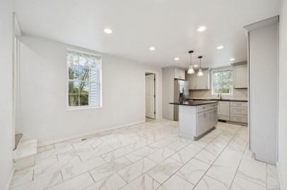 8113 Highway 22, Unit 1 New Alexandria, PA 15670 - Photo 6 of 37 a kitchen with stainless steel appliances kitchen island granite countertop a refrigerator and a sink