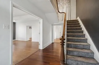 a view of an entryway with wooden floor