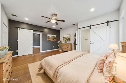 8113 Highway 22, Unit 1 New Alexandria, PA 15670 - Photo 9 of 37 a bedroom with a bed ceiling fan and a wooden floor