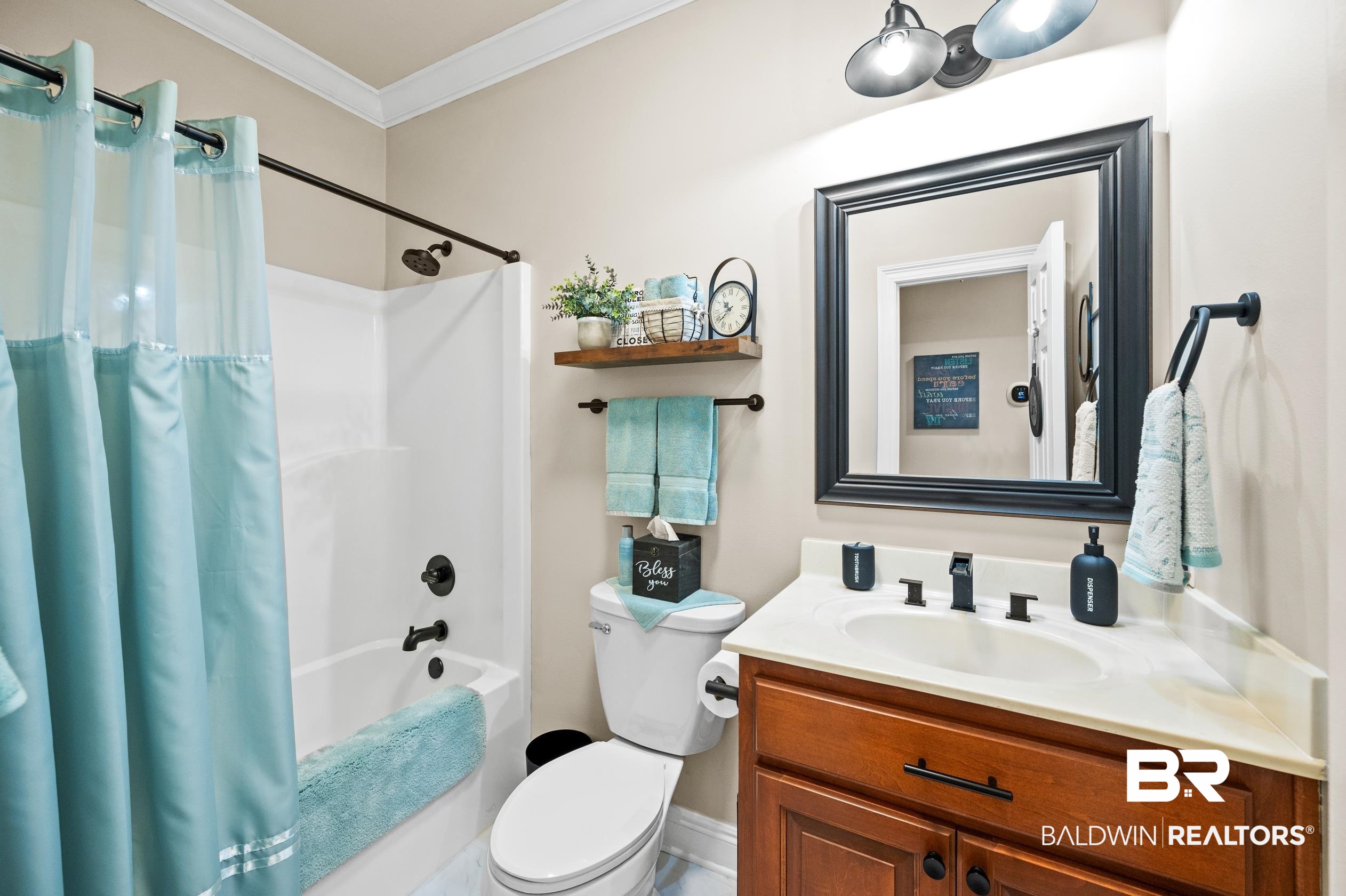 29614 St George Street Daphne, AL 36526 - Photo 29 of 42 Full bathroom featuring vanity, shower / bathtub combination with curtain, crown molding, and toilet