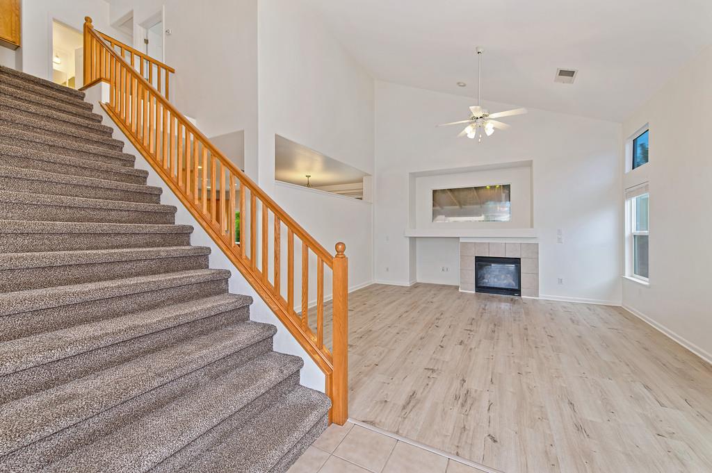 3524 Riojo Way Rancho Cordova, CA 95670 - Photo 4 of 47 a view of staircase with wooden floor and a fireplace