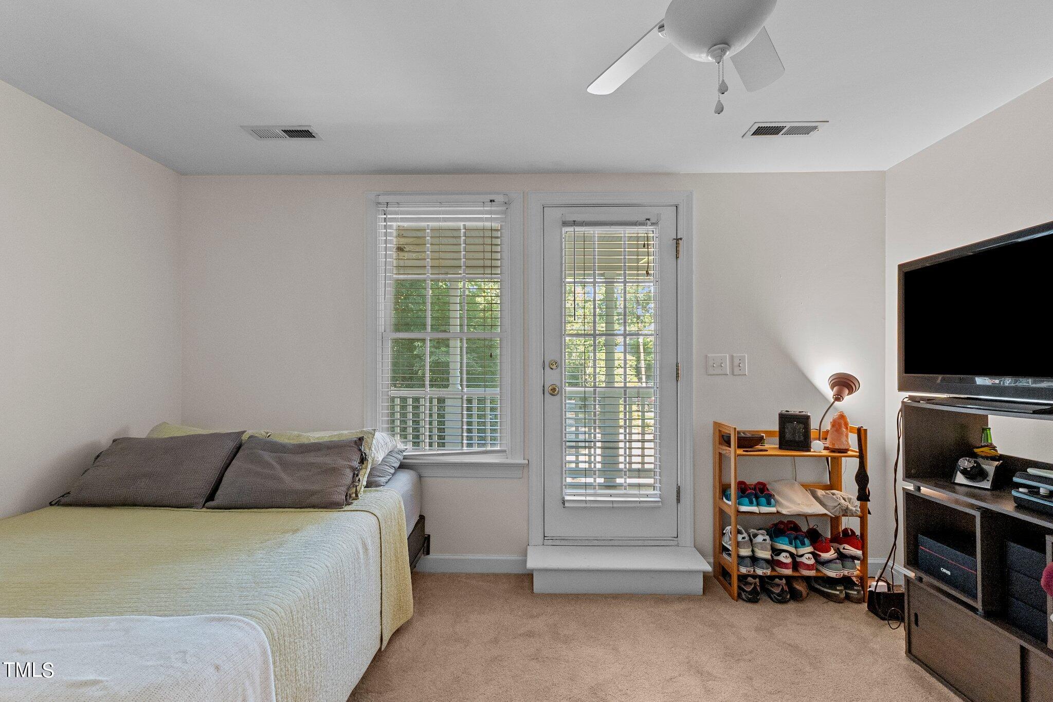 2110 Reaves Drive Raleigh, NC 27608 - Photo 16 of 36 a bedroom with furniture and a flat screen tv
