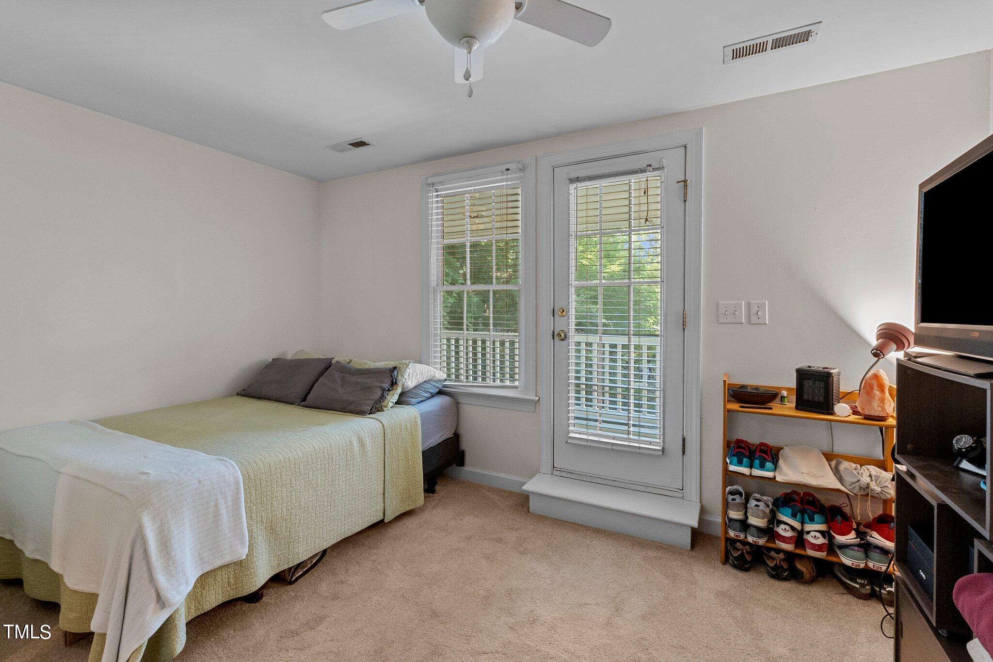 2110 Reaves Drive Raleigh, NC 27608 - Photo 17 of 36 a bedroom with a bed and a tv