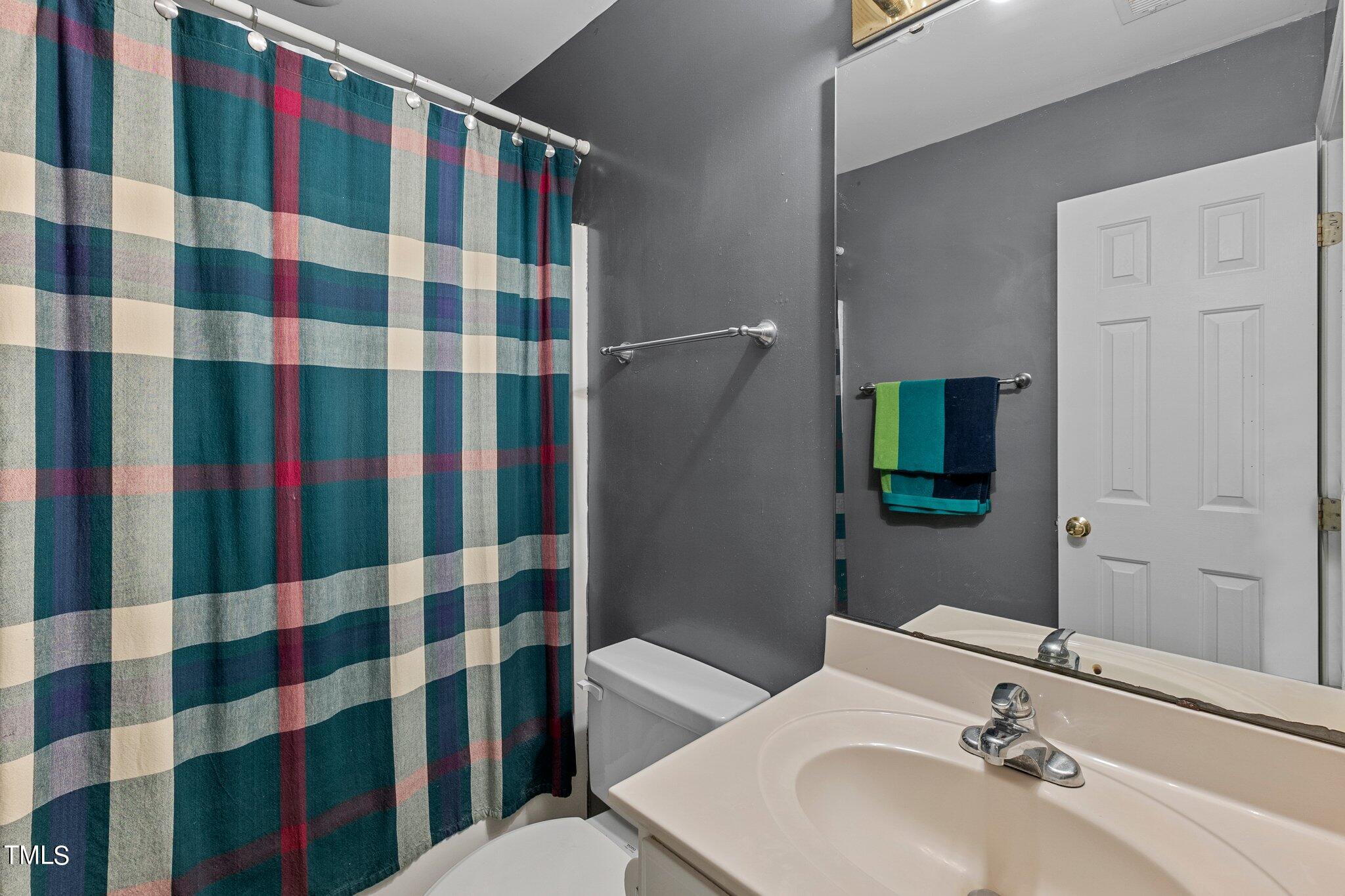 2110 Reaves Drive Raleigh, NC 27608 - Photo 20 of 36 a bathroom with a sink a toilet and shower
