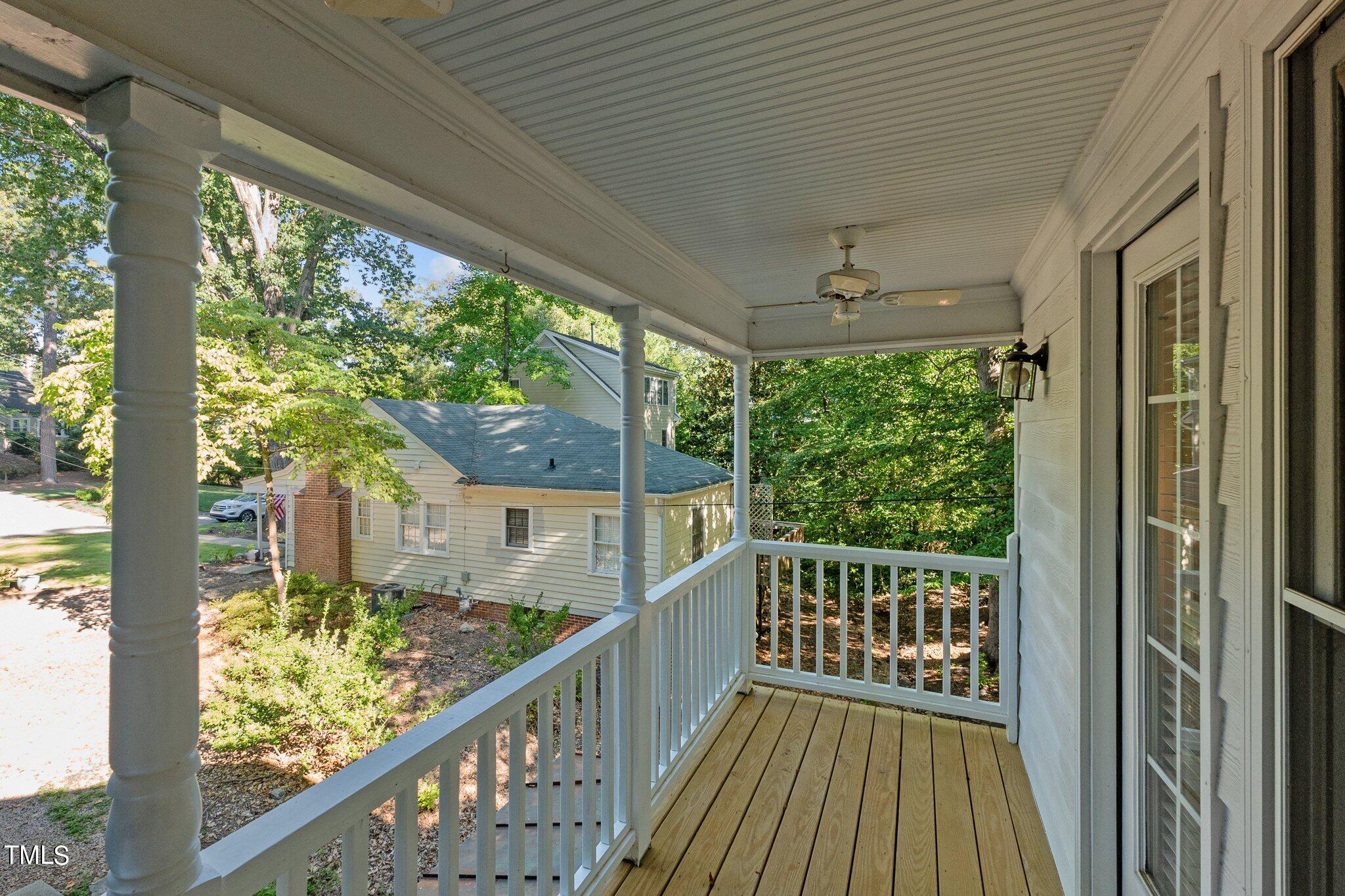 2110 Reaves Drive Raleigh, NC 27608 - Photo 2 of 36 a view of a balcony with floor to ceiling windows with wooden floor