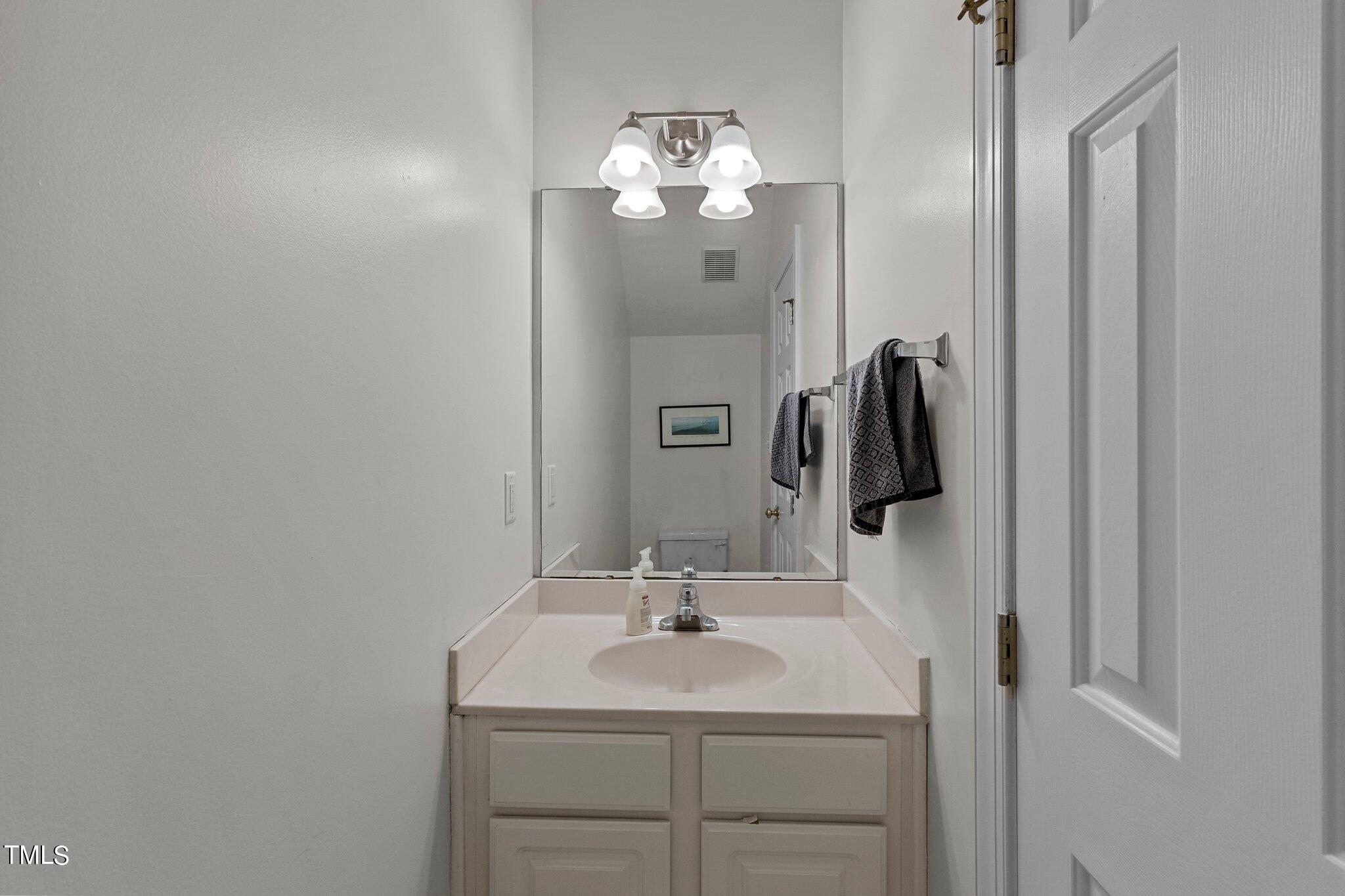 2110 Reaves Drive Raleigh, NC 27608 - Photo 22 of 36 a bathroom with a sink and a mirror