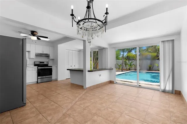 a view of a kitchen with a sink and a chandelier