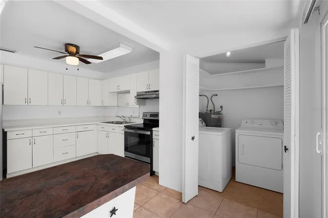 a kitchen with a sink cabinets and refrigerator