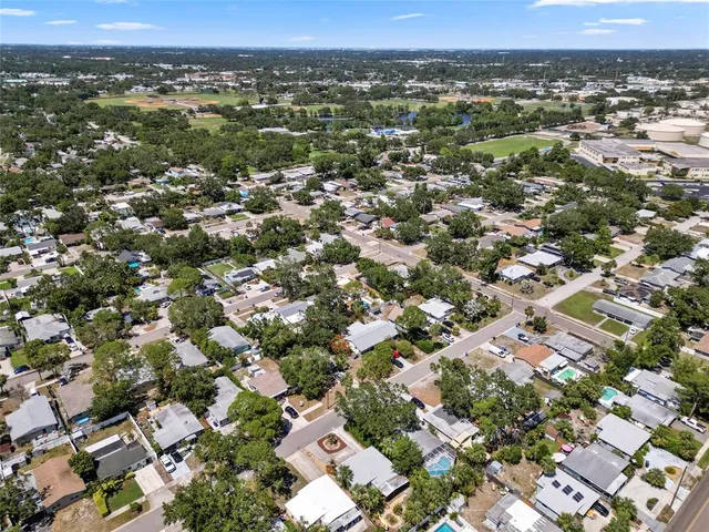 an aerial view of residential houses with city view