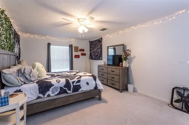 a bedroom with bed and a chandelier