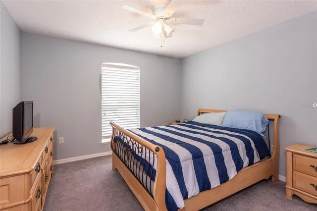 a bedroom with a bed and a tv in it