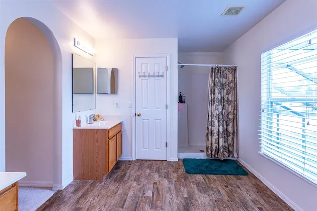 a view of room with window and wooden floor