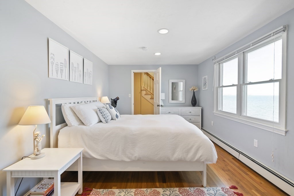 11 Lighthouse Road Scituate, MA 02066 - Photo 18 of 34 a bedroom with a bed wooden floor and window