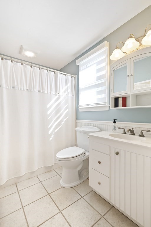 11 Lighthouse Road Scituate, MA 02066 - Photo 19 of 34 a bathroom with a granite countertop sink toilet a mirror and a window