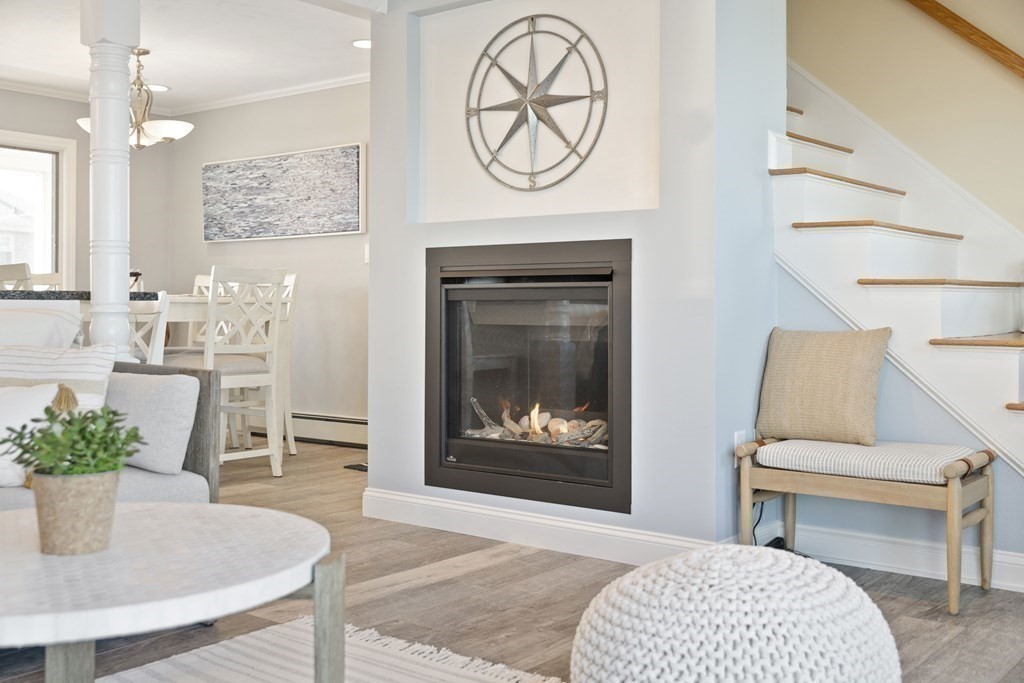 11 Lighthouse Road Scituate, MA 02066 - Photo 9 of 34 a living room with furniture a fireplace and a potted plant