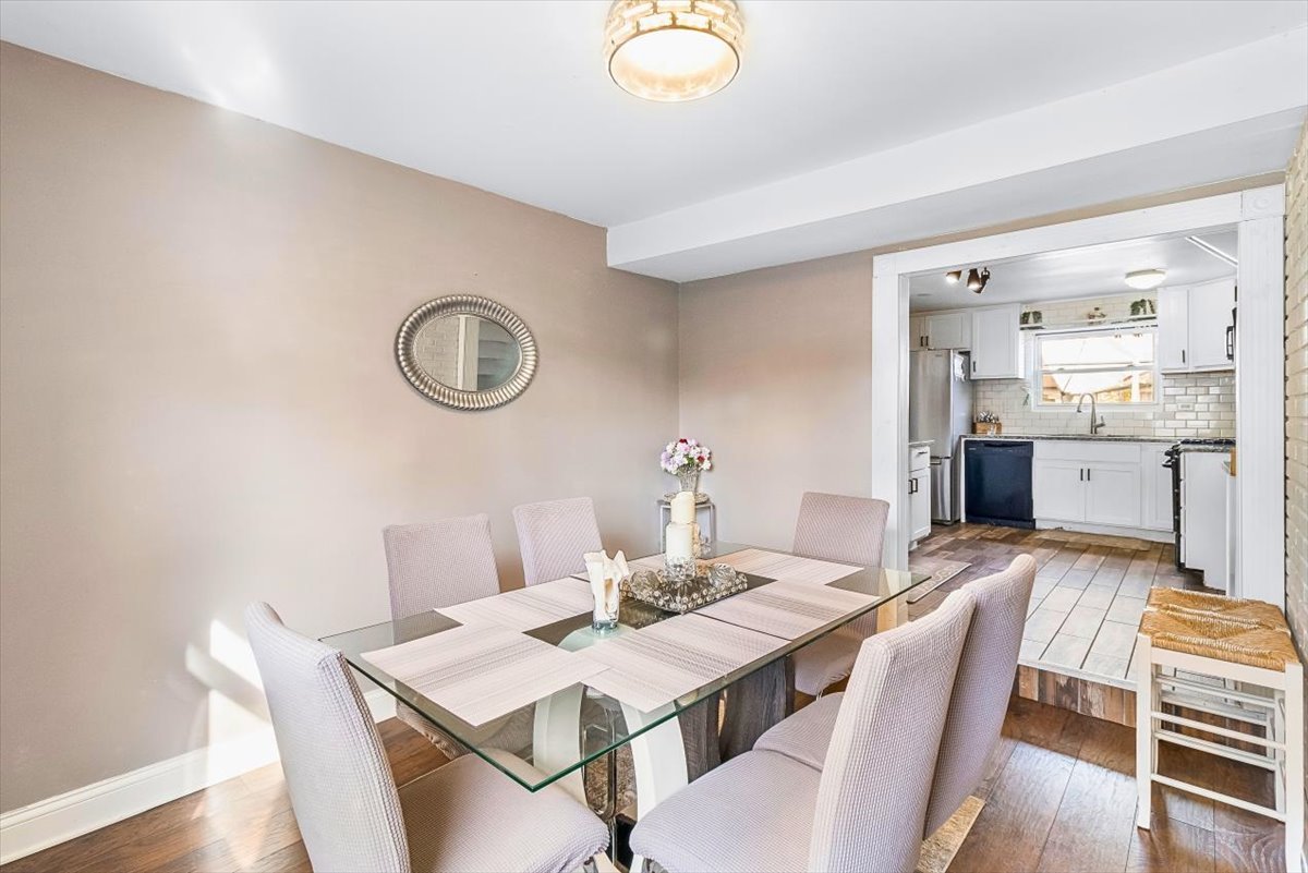 6881 Hickory Street Hanover Park, IL 60133 - Photo 16 of 23 a view of a dining room with furniture and wooden floor