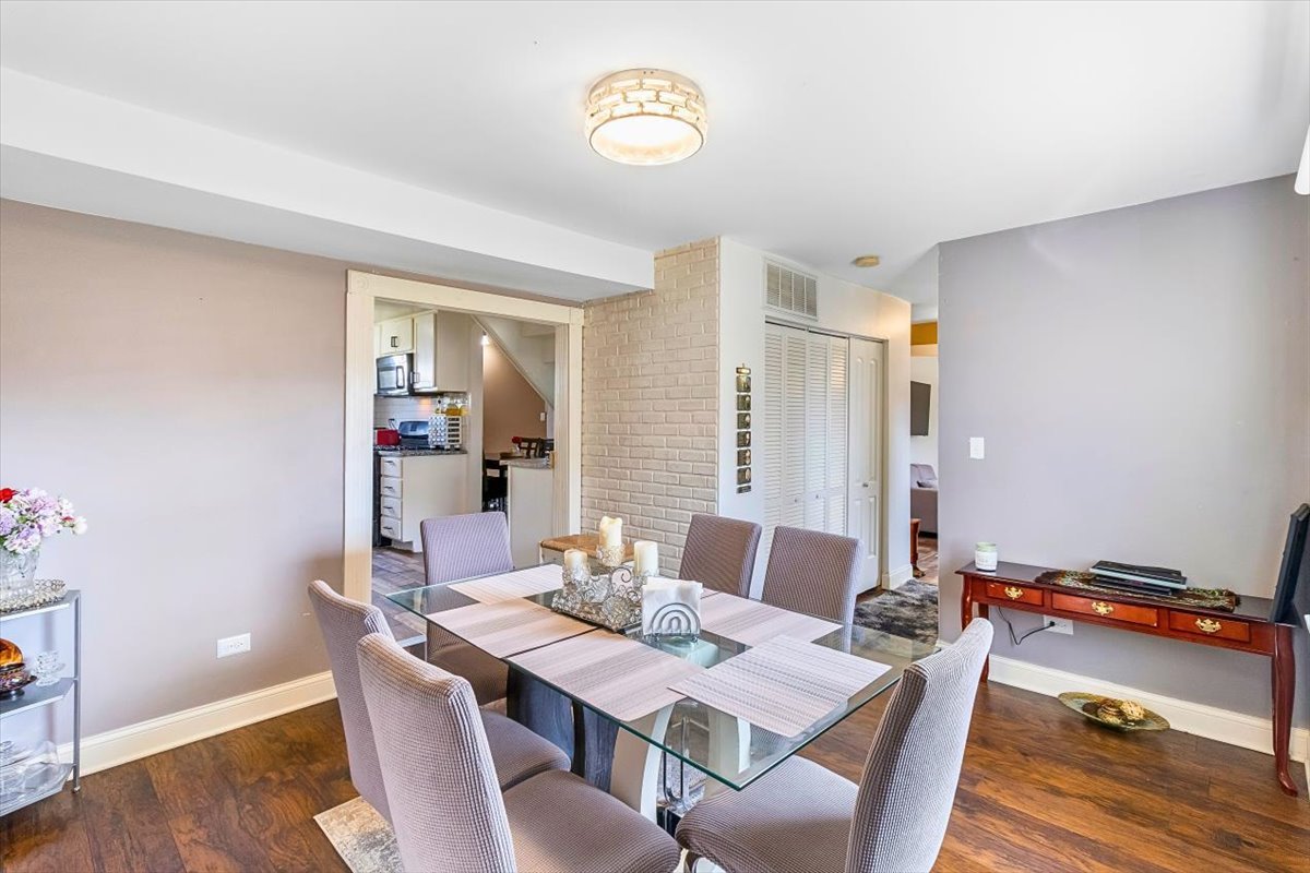 6881 Hickory Street Hanover Park, IL 60133 - Photo 17 of 23 a view of a dining room with furniture and wooden floor