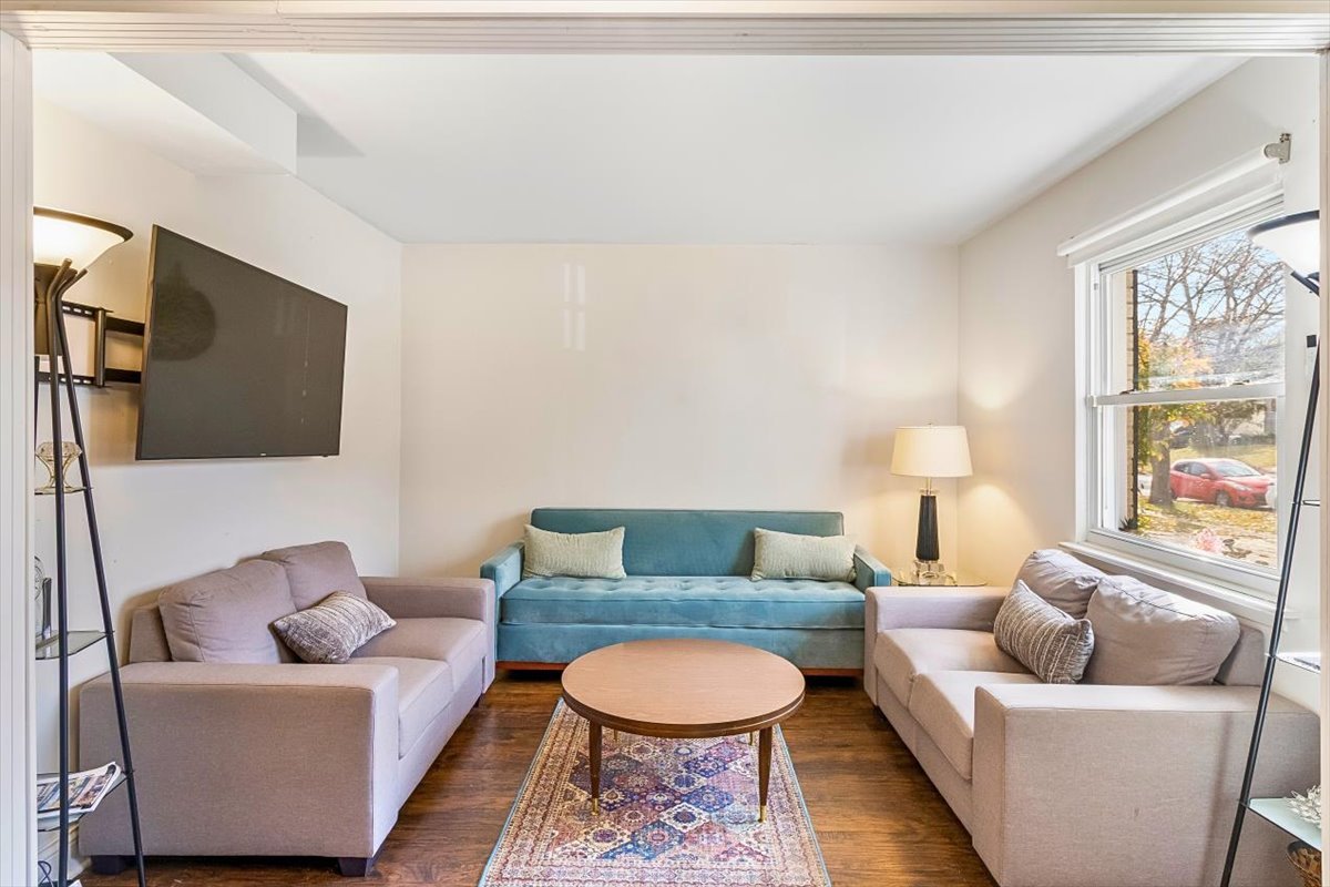 6881 Hickory Street Hanover Park, IL 60133 - Photo 18 of 23 a living room with furniture and a flat screen tv