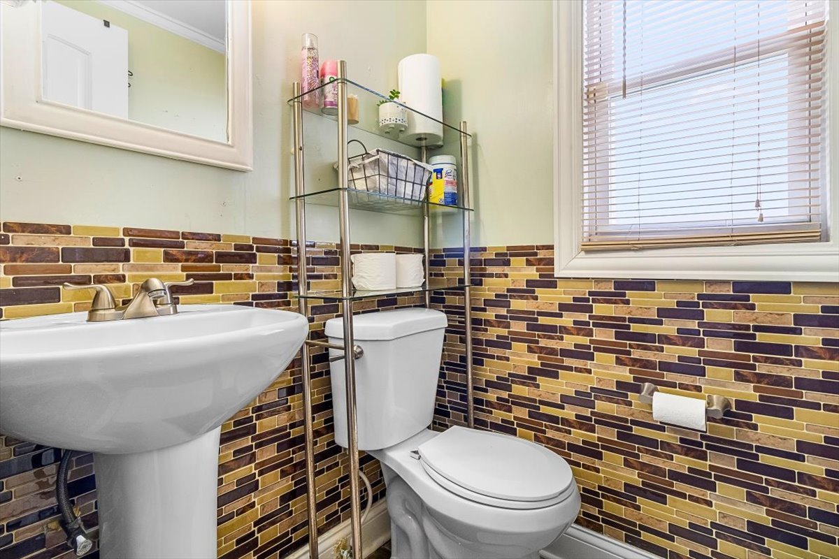 6881 Hickory Street Hanover Park, IL 60133 - Photo 19 of 23 a bathroom with a sink a toilet and a mirror
