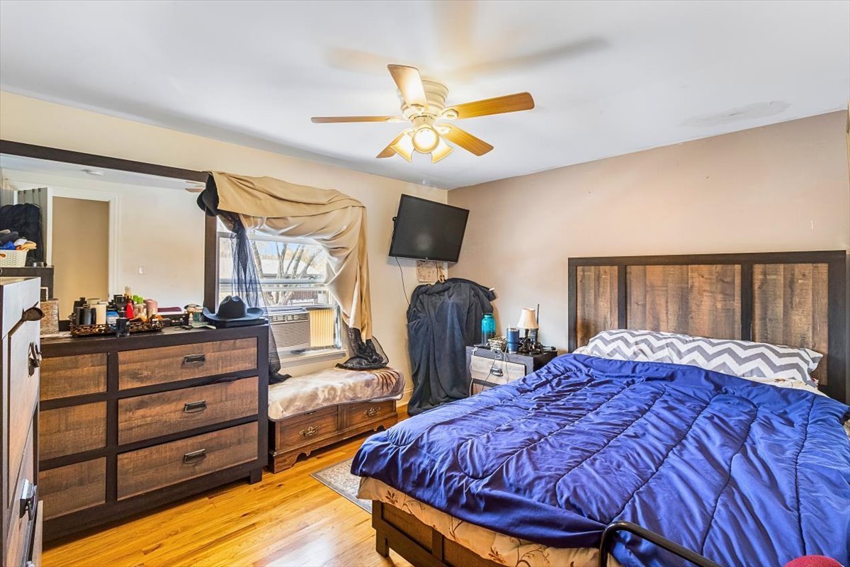 6881 Hickory Street Hanover Park, IL 60133 - Photo 8 of 23 a bedroom with bed and wooden floor