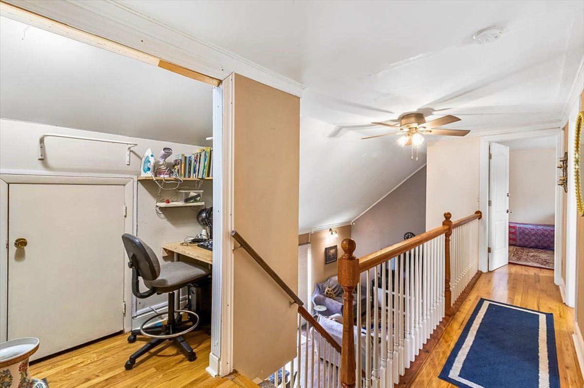 6881 Hickory Street Hanover Park, IL 60133 - Photo 9 of 23 a view of a hallway with workspace and wooden floor