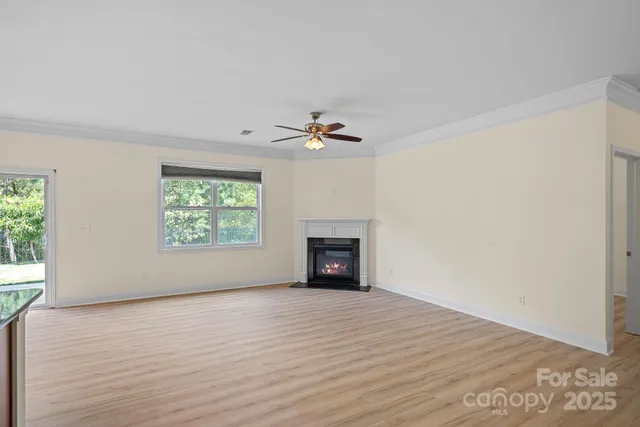 wooden floor fireplace and windows in an empty room