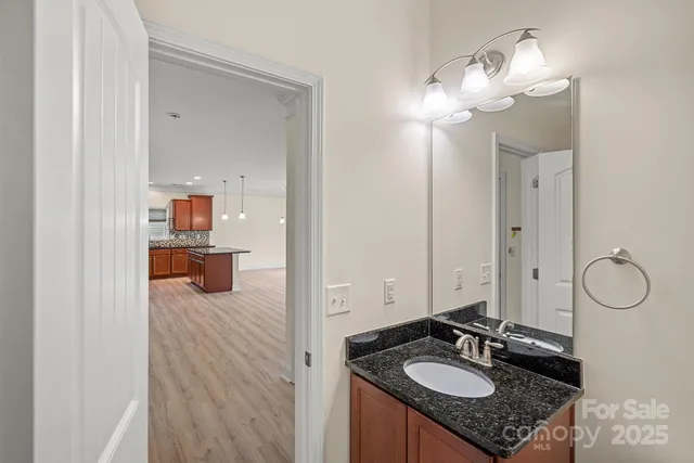 a bathroom with a sink vanity and mirror