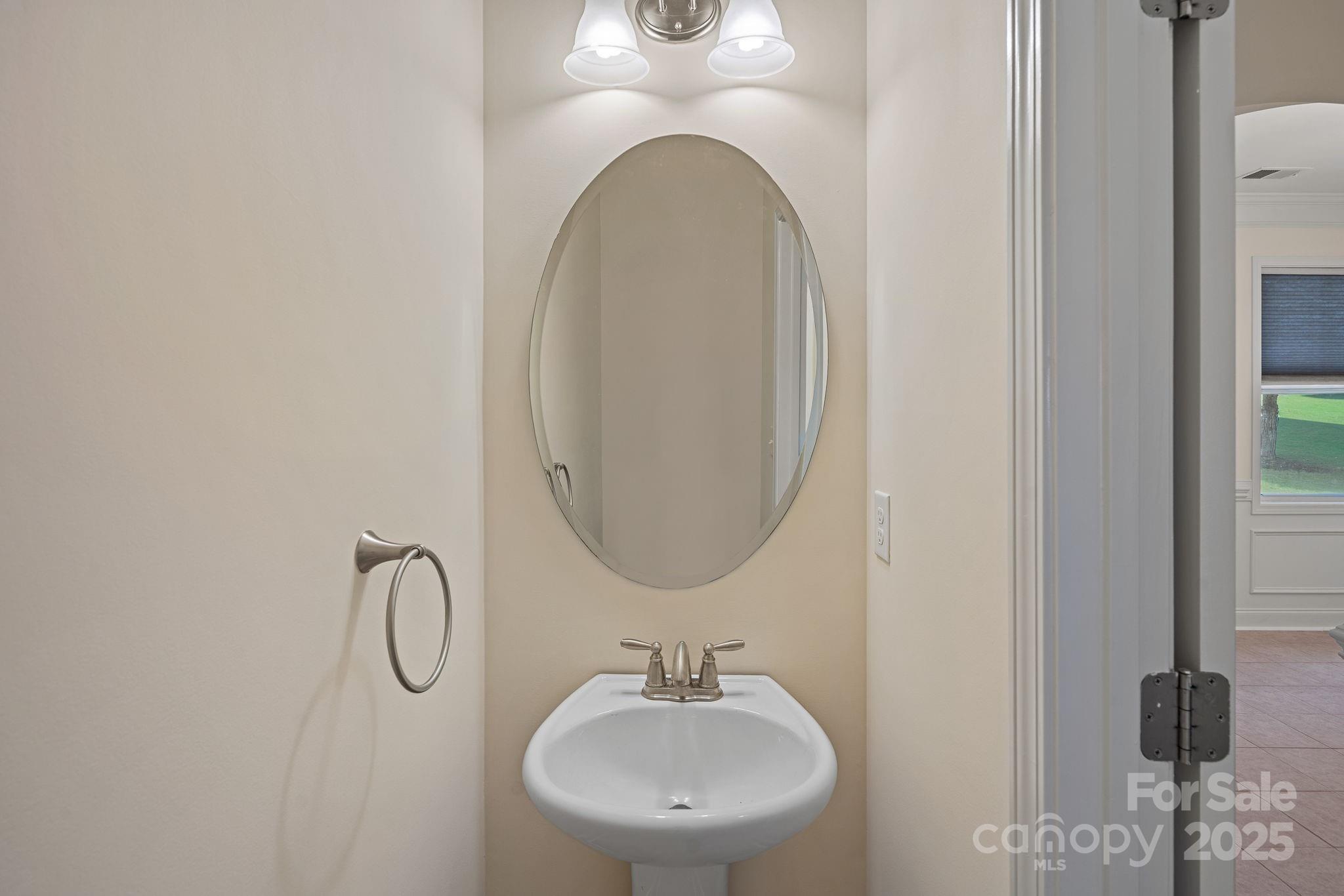 2079 Lakebridge Drive Fort Mill, SC 29715 - Photo 16 of 33 a bathroom with a sink and a mirror