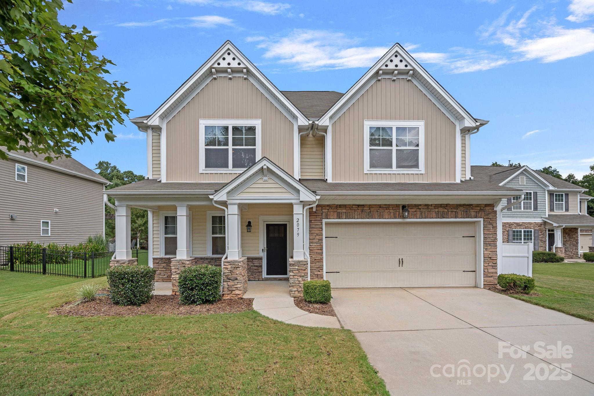 2079 Lakebridge Drive Fort Mill, SC 29715 - Photo 2 of 33 a front view of a house with a yard and garage