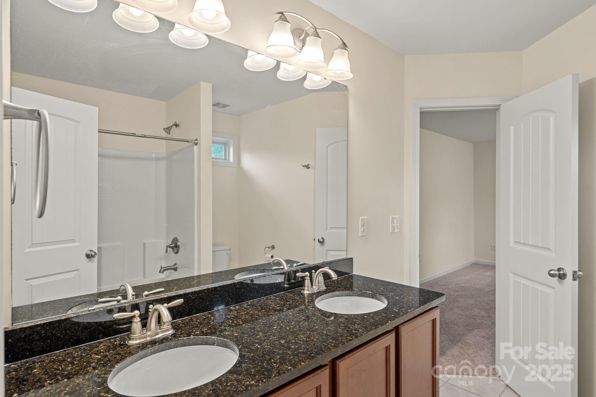 2079 Lakebridge Drive Fort Mill, SC 29715 - Photo 22 of 33 a bathroom with a granite countertop double vanity sinks and a mirror