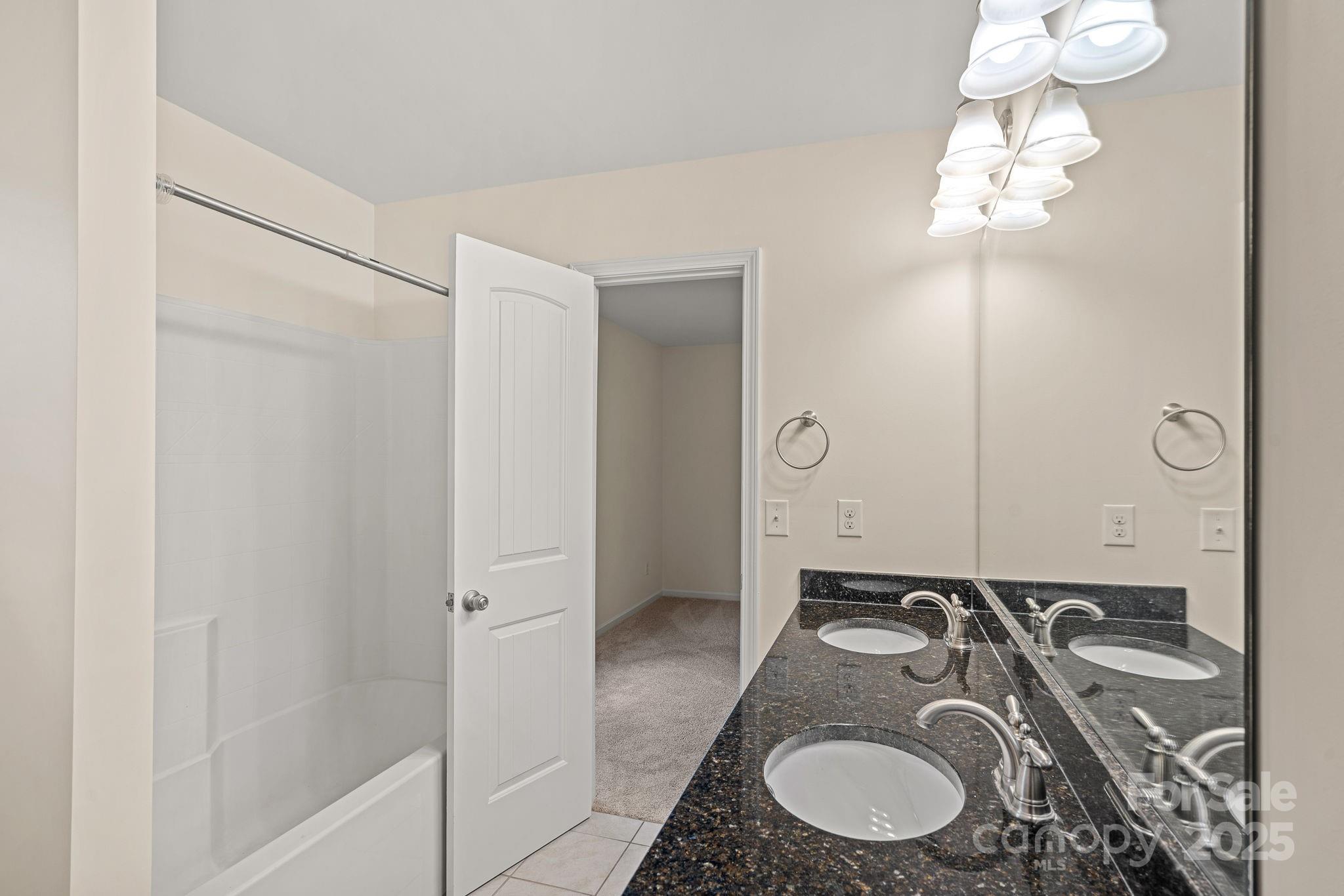 2079 Lakebridge Drive Fort Mill, SC 29715 - Photo 23 of 33 a bathroom with a granite countertop double vanity sink and mirror