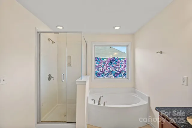 a bathroom with a bathtub and a shower