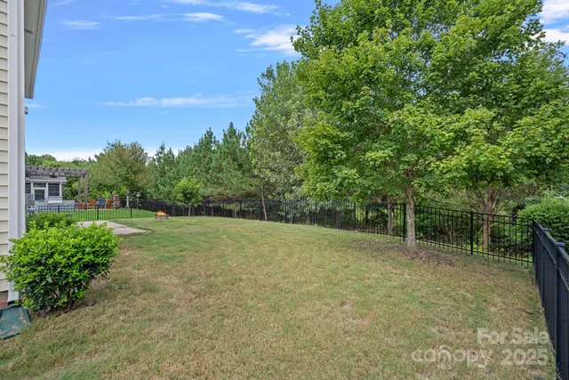 a view of a field with trees in the background