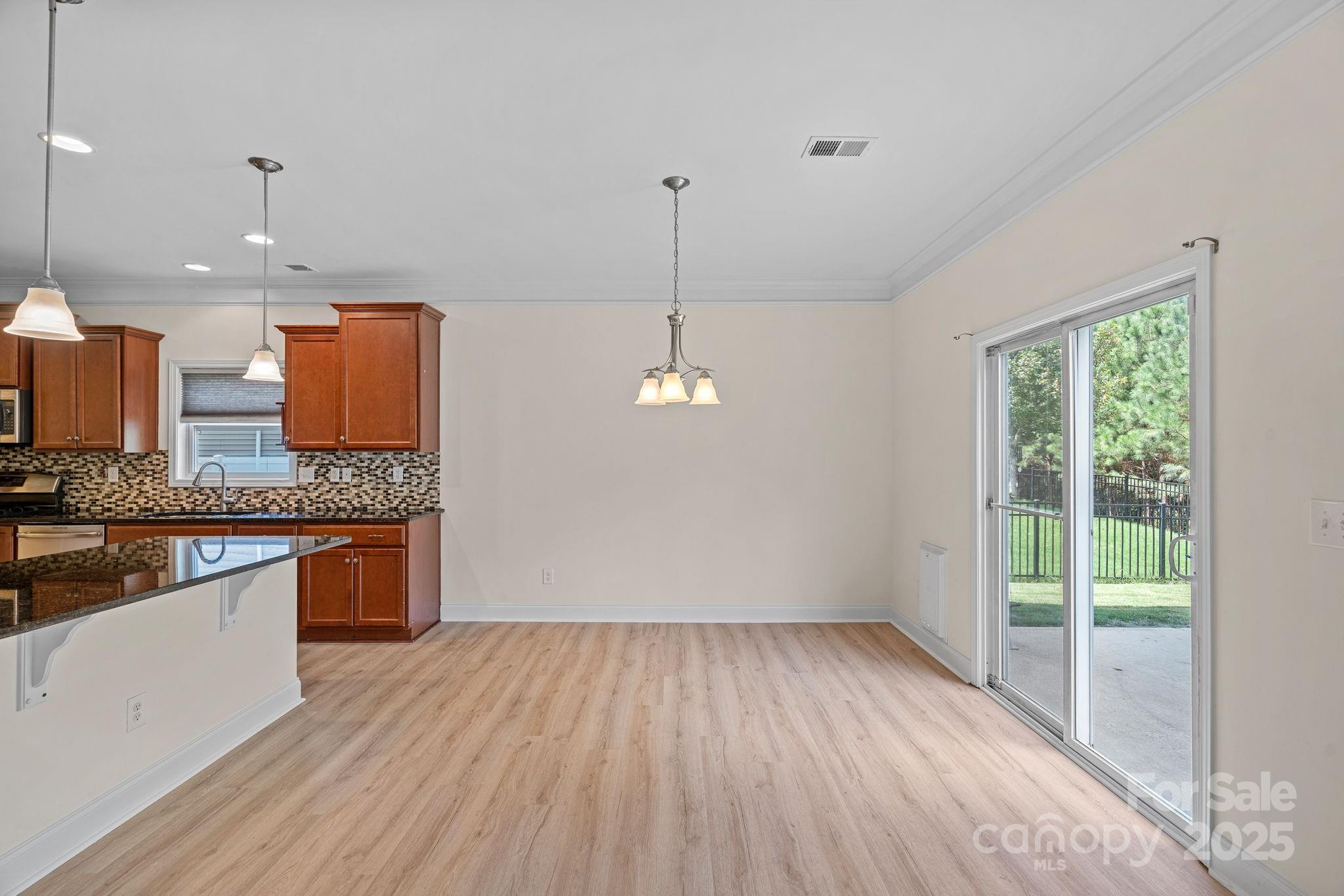 2079 Lakebridge Drive Fort Mill, SC 29715 - Photo 10 of 33 a kitchen with stainless steel appliances granite countertop a stove a sink and a wooden floors