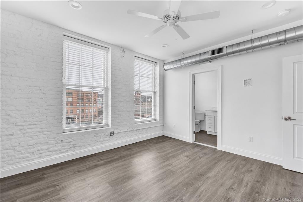475 Howe Avenue, Unit 5 Shelton, CT 06484 - Photo 13 of 31 wooden floor in an empty room with a window