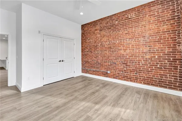 a view of an empty room with wooden floor