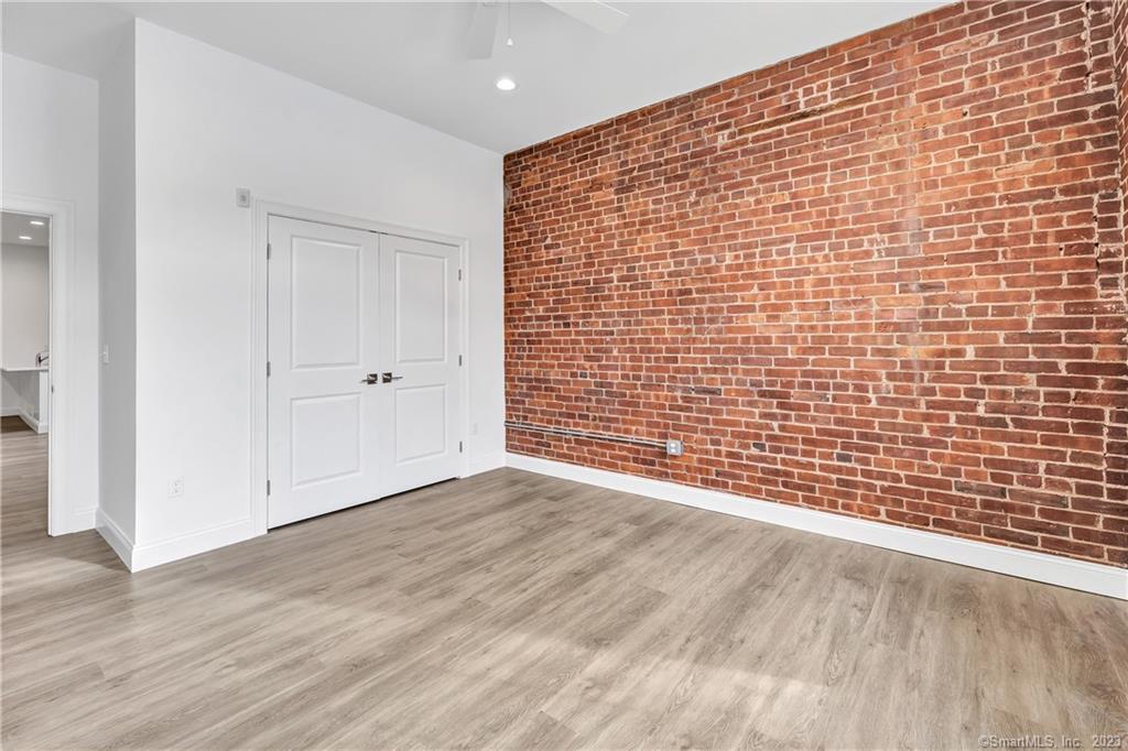 475 Howe Avenue, Unit 5 Shelton, CT 06484 - Photo 17 of 31 a view of an empty room with wooden floor