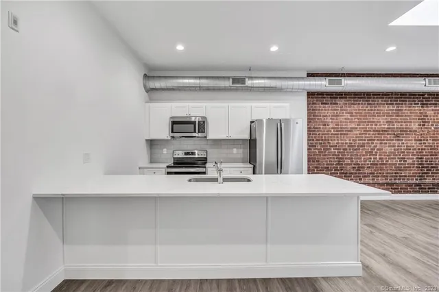 a kitchen with stainless steel appliances a refrigerator and a stove