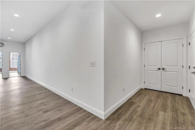 a view of a room with wooden floor
