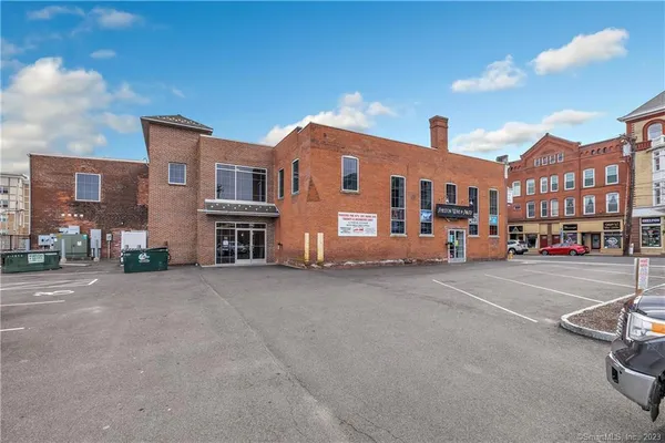 a couple of cars parked in front of a building