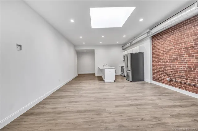a view of a livingroom with wooden floor and chair