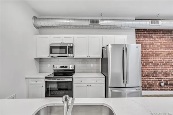 a kitchen with a refrigerator stove and microwave