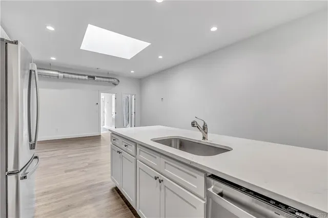 a kitchen with a sink and refrigerator