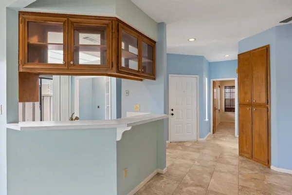 a view of a kitchen with refrigerator and cabinet